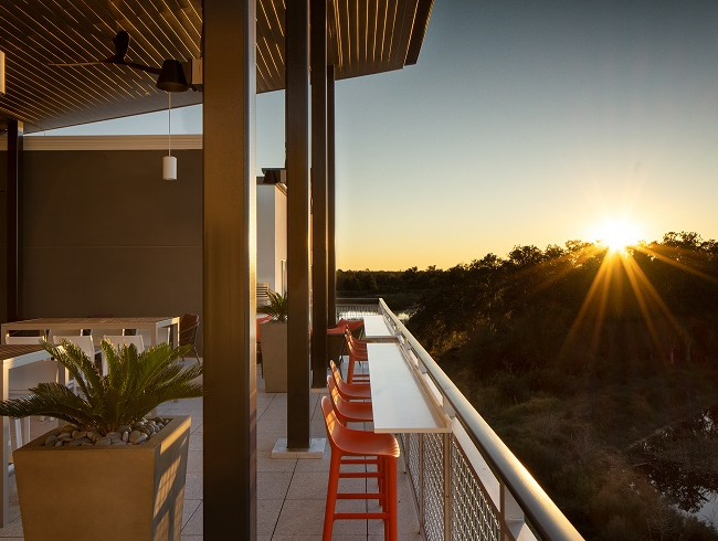 image of rooftop bar outdoor seating at sunset